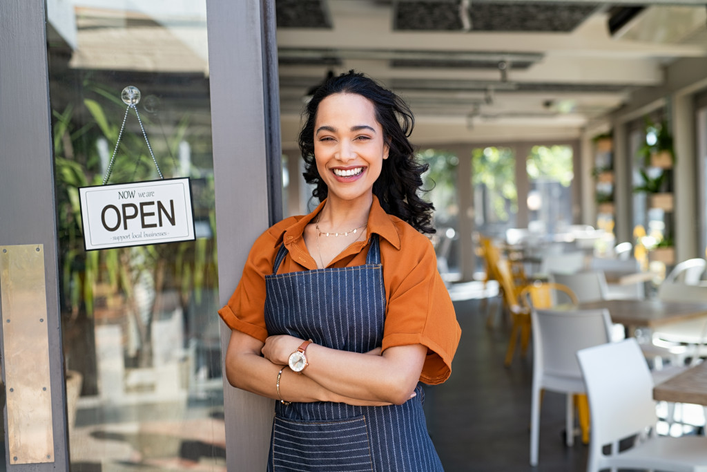 restaurant waitress smiling and standing by entrance